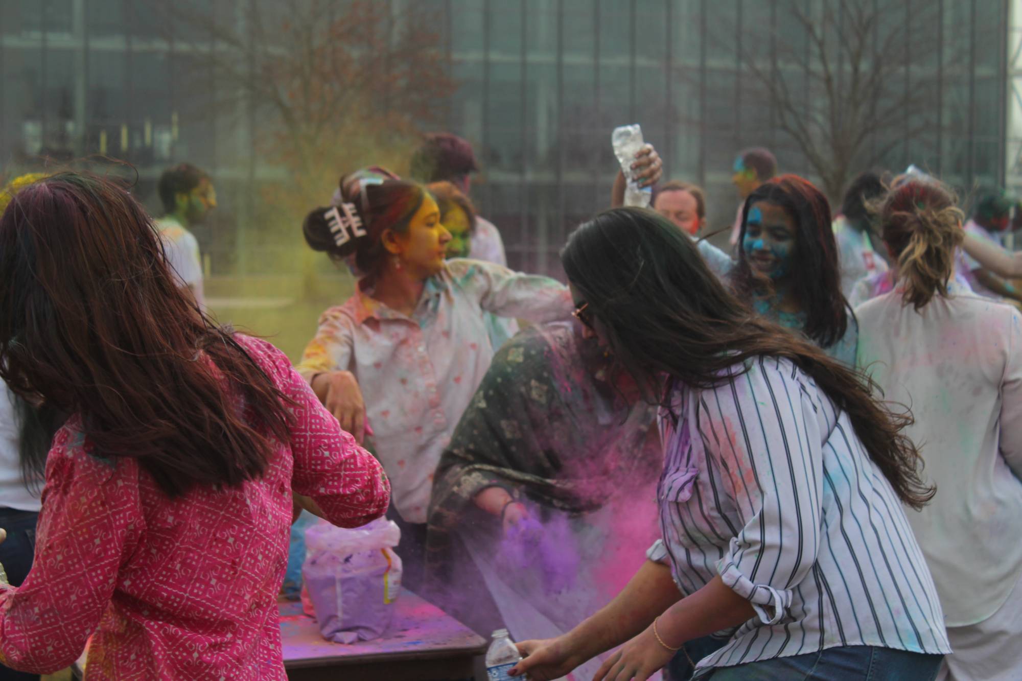 Students throw colorful powder to celebrate Holi